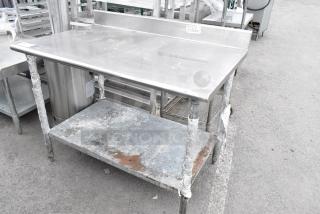 Stainless Steel Table w/ Back Splash and Metal Under Shelf.