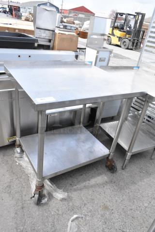 Stainless Steel Table w/ Metal Under Shelf on Commercial Casters.
