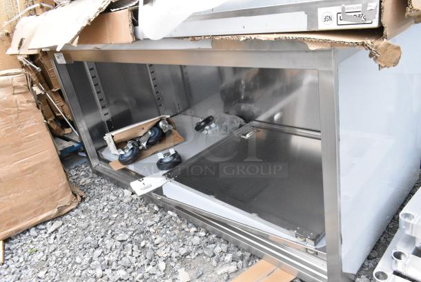 BRAND NEW SCRATCH AND DENT! Regency 600EBT3060D 30" x 60" 16 Gauge Type 304 Stainless Steel Enclosed Base Table with Sliding Doors and Adjustable Midshelf - Image 1 of 4