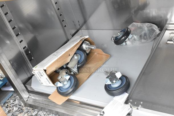 BRAND NEW SCRATCH AND DENT! Regency 600EBT3060D 30" x 60" 16 Gauge Type 304 Stainless Steel Enclosed Base Table with Sliding Doors and Adjustable Midshelf - Image 3 of 4