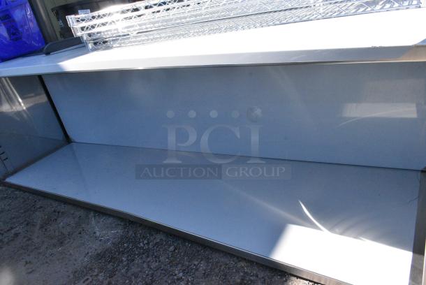 BRAND NEW SCRATCH AND DENT! Regency 600EBT3096 30" x 96" 16 Gauge Type 304 Stainless Steel Enclosed Base Table with Open Front and Adjustable Midshelf - Image 3 of 4