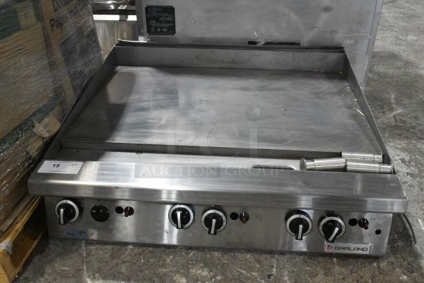 LIKE NEW! Garland Stainless Steel Commercial Countertop Natural Gas Powered Flat Top Griddle w/ Thermostatic Controls. - Image 1 of 6