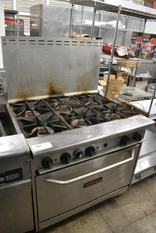 Tri-Star TSR-6 Stainless Steel Commercial Natural Gas Powered 6 Burner Range w/ Oven and Back Splash on Commercial Casters.