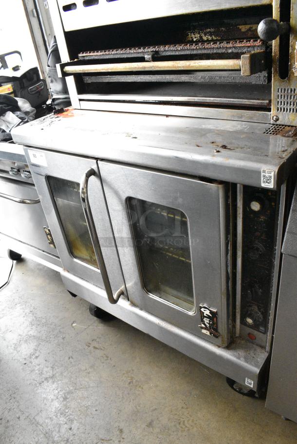 Montague Stainless Steel Commercial Natural Gas Powered Full Size Convection Oven w/ View Through Doors, Metal Oven Racks and Thermostatic Controls on Commercial Casters. - Image 1 of 8