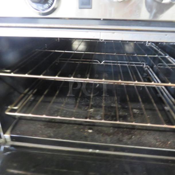 One Southbend 6 Burner/Griddle Natural Gas Range  With 4 Racks On Casters, 24 Inch Griddle With A Stainless Steel Over Shelf. 60.5X34.5X59.5. Model# S60DD-2GR. $8046.45 - Image 4 of 5