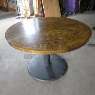 One Round Wooden Table Top On A Round Pedestal Base. 48X48X30