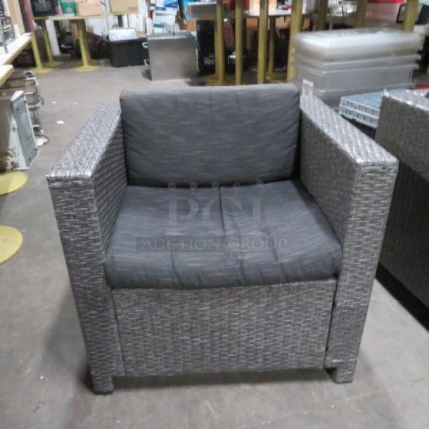 One Gray Wicker Patio Chair With Cushion. 9.5X25.5X26.5 - Image 1 of 3
