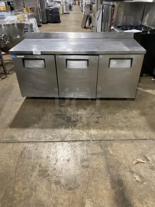 True Commercial Stainless Steel 3 Door Refrigerated 72" Worktop Table! Energy Star Certified! With Up Turned Back Splash! With Poly Coated Wire Racks! Model: TWT-72 SN: 7702017! 115V 1 Phase! On Casters!
