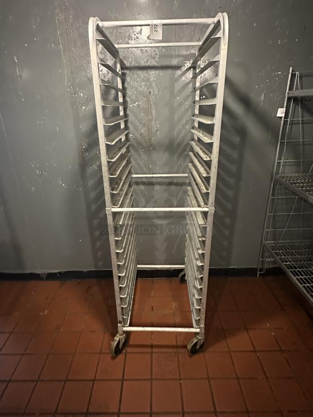 ALMOST PERFECT! Intermediate Height 18 Level 64" End Load Rack. Condition: 8/10 A hard working, versatile line of racks Construction: High tensile extruded aluminum Dimensions: 64"H x 21 3/8"W x 26 1/2"D Tray supports: 1-1/2″ wide extruded pan supports riveted to uprights Center Spacing: 3" Pan Capacity: (18) 18" x 26" pans Casters: 5" non-marking swivel threaded stem Actual Weight: 45 lbs. - Image 1 of 2