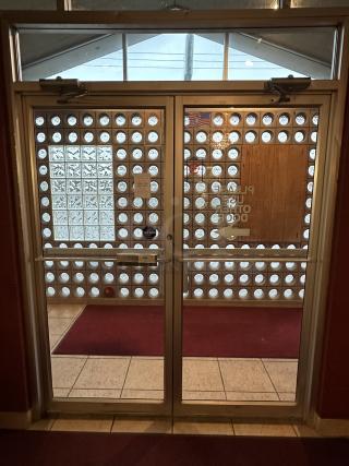 Complete Entry/Exit Metal Frame Door System. Includes Framework, 2 Glass Doors,  Auto Closures and top Glass Window Panels. BUYER MUST REMOVE. Door Size: 40"x84" Winning Bidder takes everything! Double Door with Glass Across Top, Locking Swing Out