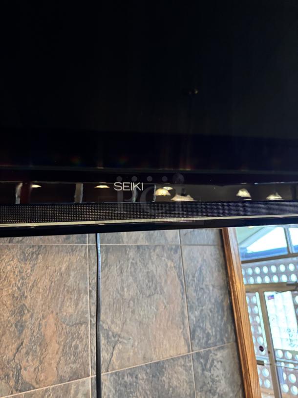 Seiki TV, on swivel base mounted to wall, 20X30 with remote - Image 4 of 5