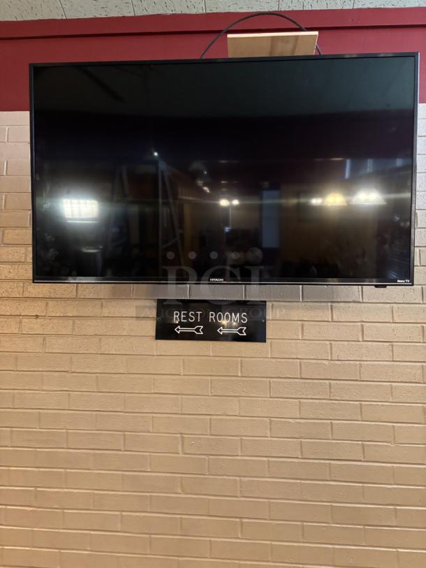 Hitachi Roku TV, swivel mounted to wall, you are responsible for detaching, powered on working 25x43in, with remote - Image 1 of 3