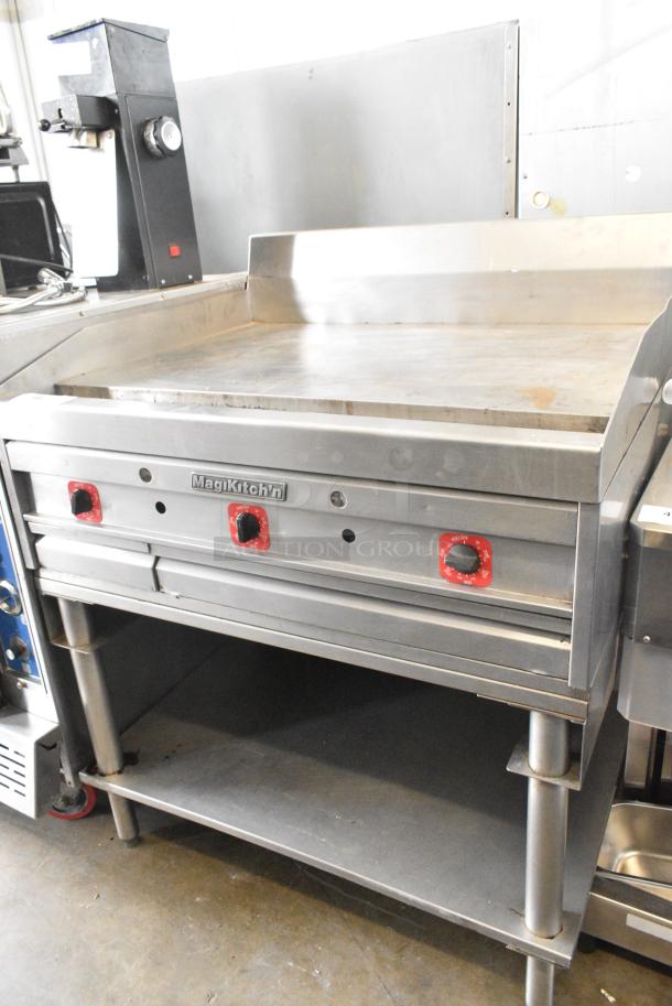 MagiKitch'n Stainless Steel Commercial Natural Gas Powered Flat Top Griddle w/ Thermostatic Controls and Metal Under Shelf. - Image 1 of 5
