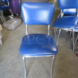 Chrome Chair With A Blue Cushioned Seat And Back. 2XBID