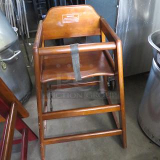One Wooden High Chair With Safety Straps.