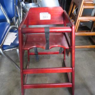 One Wooden High Chair With Safety Straps.