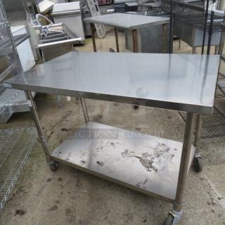 One Stainless Steel Table With A SS Under Shelf On Casters. 48X30X35