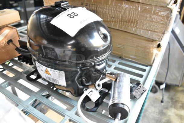 BRAND NEW SCRATCH AND DENT! Embraco EM2X3117U Compressor. 115-127 Volts, 1 Phase. - Image 1 of 4