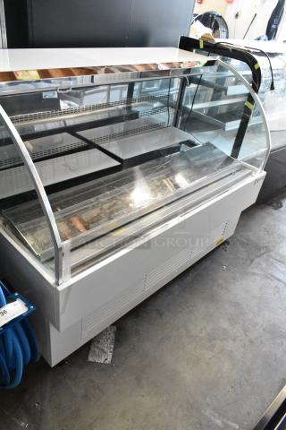 BRAND NEW SCRATCH AND DENT! Avantco 193HAC63W  59 1/8" White Horizontal Air Curtain Merchandiser with 1 Shelf and LED Lighting on Commercial Casters. 115 Volts, 1 Phase.