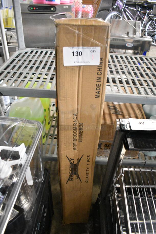 BRAND NEW SCRATCH AND DENT! Regency 600MBR36 36" Stainless Steel Mop / Broom Rack with 4 Holders - Image 1 of 4
