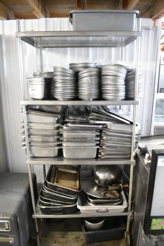 Metal 4 Tier Shelving Unit w/ Contents Including Stainless Steel Drop In Bins and Metal Baking Pans. BUYER MUST DISMANTLE. PCI CANNOT DISMANTLE FOR SHIPPING. PLEASE CONSIDER FREIGHT CHARGES.