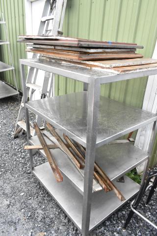 Metal 4 Tier Shelving Unit w/ Contents. BUYER MUST DISMANTLE. PCI CANNOT DISMANTLE FOR SHIPPING. PLEASE CONSIDER FREIGHT CHARGES.