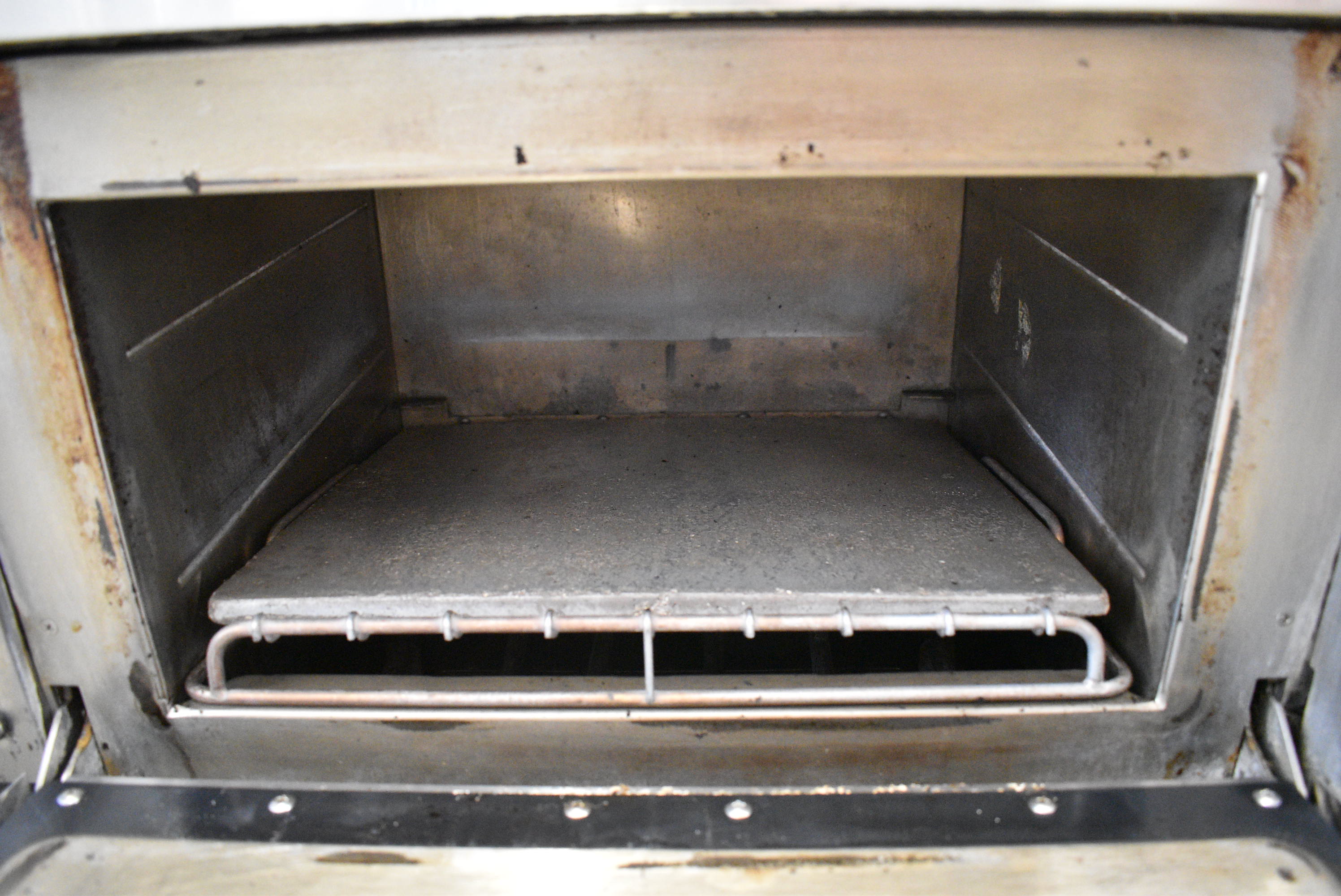 Rapid-cook oven interior with ceramic cooking stone installed
