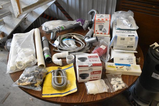 ALL ONE MONEY! Lot of Various BRAND NEW SCRATCH AND DENT! Items Including Security Camera, Water Hoses, Molded Undersink Pipe Covers and Pipes in Clear Poly Bin - Image 1 of 21