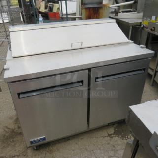 One Artic Air 2 Door Refrigerated Prep Table With 2 Racks On Casters. Model# AST48RZ. 115 Volt. Working NOT COLD. 49X30X44