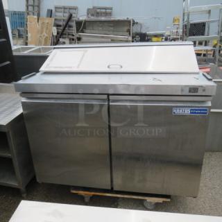 One Kratos 2 Door Refrigerated Prep Table With 2 Racks On Casters. Model# 69K-770HC. 115 Volt. 48X32X44