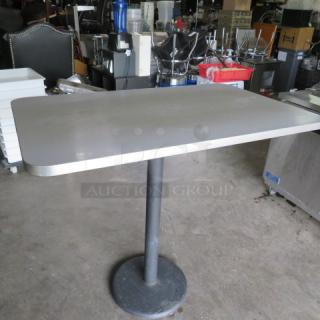 One Gray Laminate Table Top On A Bar Height Pedestal Base. 48X30X42