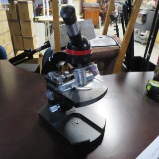 One Olympus Lumiscope Microscope. #Z65771.