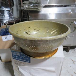 One 16 Inch Aluminum Colander.