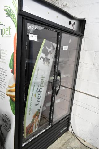 2021 True TVM-48SL-HC Metal Commercial 2 Door Reach In Cooler Merchandiser w/ Shelves. See Pictures for Broken Glass on Door. 115 Volts, 1 Phase. Tested and Working!