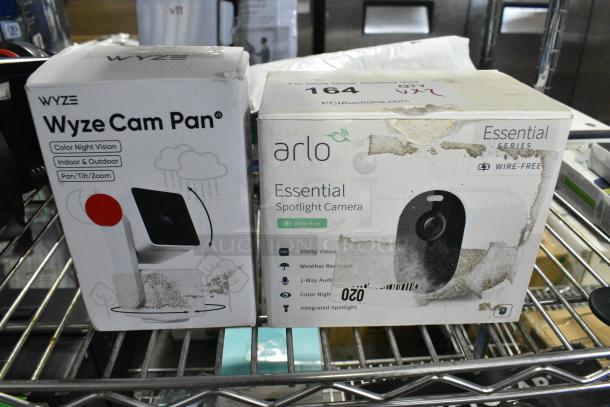 2 Various IN ORIGINAL BOX Items Including Wyze Cam Pan Camera and Arlo Essential Spotlight Camera. 2 Times Your Bid! - Image 1 of 5