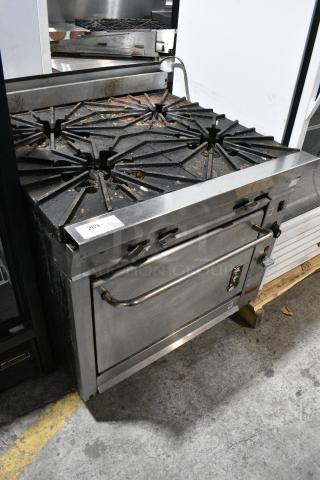 Montague V136-5A Vectaire Stainless Steel Commercial Natural Gas Powered 4 Burner Range w/ Convection Oven on Commercial Casters.
