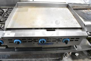 Bakers Pride Stainless Steel Commercial Countertop Natural Gas Powered Flat Top Griddle.