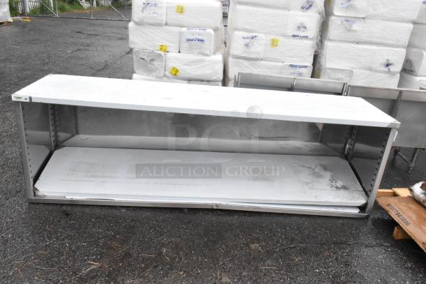 BRAND NEW SCRATCH AND DENT! Regency 600EBT2496 24" x 96" 16 Gauge Type 304 Stainless Steel Enclosed Base Table with Open Front and Adjustable Midshelf - Image 2 of 3