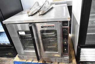 Garland Master 200 Stainless Steel Commercial Electric Powered Full Size Convection Oven w/ View Through Doors, Metal Oven Racks, Thermostatic Controls and Metal Legs. 240 Volts, 1 Phase.