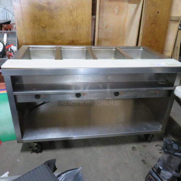 One Delfield 4 Well Electric Steam Table With A Cutting Board, And  SS Under Shelf On Casters. WORKING WHEN REMOVED,.  Model# EHE160C. 208-230 Volt. 1 Phase. Hardwired.  60X31.5X37. $5409.00 - Image 2 of 4
