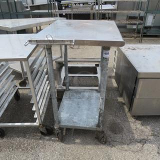 One Stainless Steel Table Woth Under Shelf On Casters With A Bagger. 30X24X40