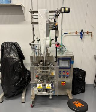 Lenis LMSTS-300L Metal Commercial Floor Style VFFS Sachet Packing Machine on Commercial Casters. 220 Volts. Picture of Unit Before Removal Is Used as Gallery Picture