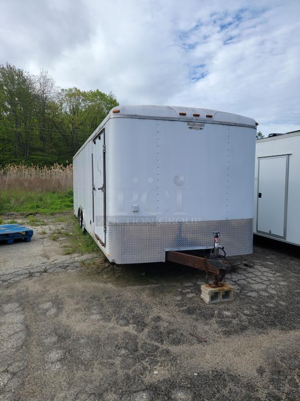 24' Continental Cargo Enclosed Tandem Axle Trailer! Comes with spare tire.*CONTENTS NOT INCLUDED* Equipped with overhead lighting, wood paneling interior, shelving, and electrical outlets! - This item is off site in Biddeford. - Image 1 of 15