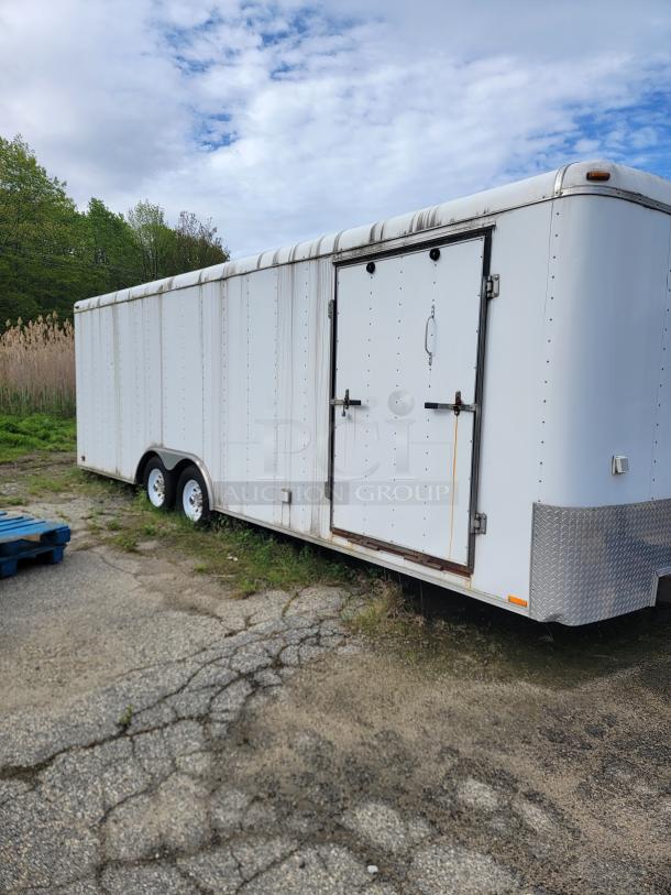 24' Continental Cargo Enclosed Tandem Axle Trailer! Comes with spare tire.*CONTENTS NOT INCLUDED* Equipped with overhead lighting, wood paneling interior, shelving, and electrical outlets! - This item is off site in Biddeford. - Image 2 of 15