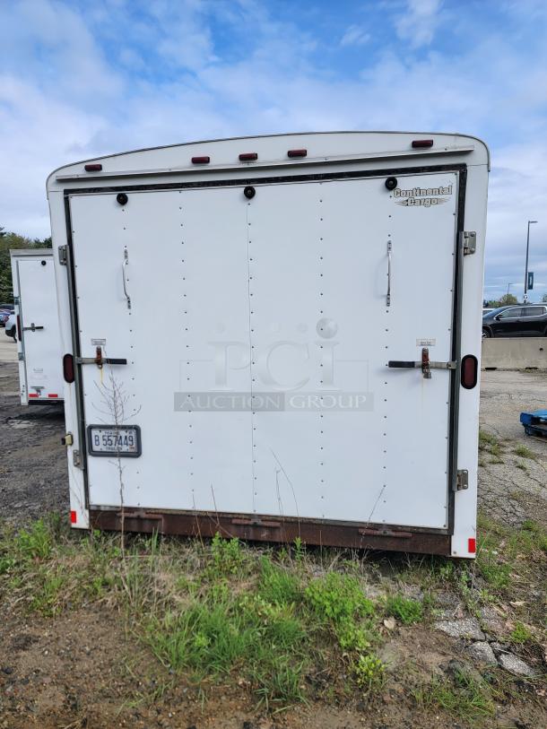 24' Continental Cargo Enclosed Tandem Axle Trailer! Comes with spare tire.*CONTENTS NOT INCLUDED* Equipped with overhead lighting, wood paneling interior, shelving, and electrical outlets! - This item is off site in Biddeford. - Image 4 of 15