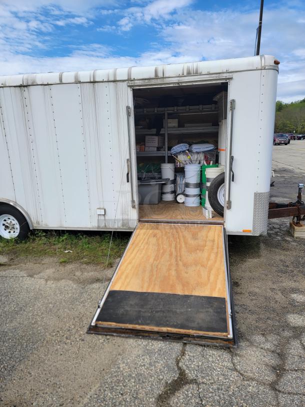 24' Continental Cargo Enclosed Tandem Axle Trailer! Comes with spare tire.*CONTENTS NOT INCLUDED* Equipped with overhead lighting, wood paneling interior, shelving, and electrical outlets! - This item is off site in Biddeford. - Image 5 of 15