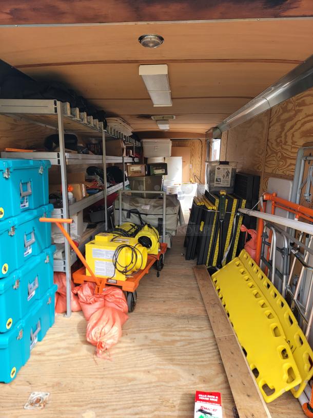 24' Continental Cargo Enclosed Tandem Axle Trailer! Comes with spare tire.*CONTENTS NOT INCLUDED* Equipped with overhead lighting, wood paneling interior, shelving, and electrical outlets! - This item is off site in Biddeford. - Image 14 of 15