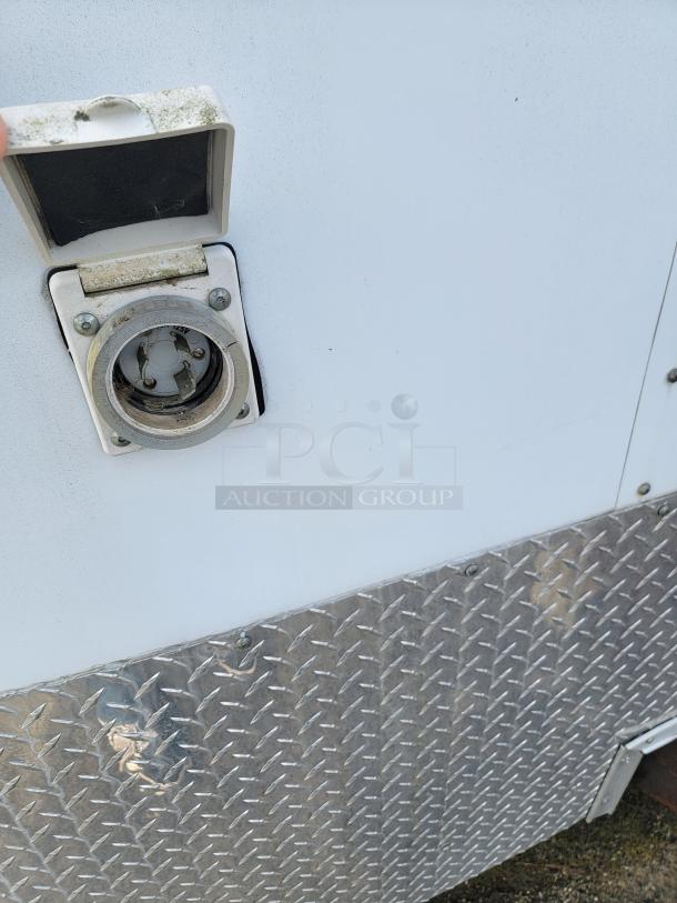 24' Continental Cargo Enclosed Tandem Axle Trailer! Comes with spare tire.*CONTENTS NOT INCLUDED* Equipped with overhead lighting, wood paneling interior, shelving, and electrical outlets! - This item is off site in Biddeford. - Image 15 of 15