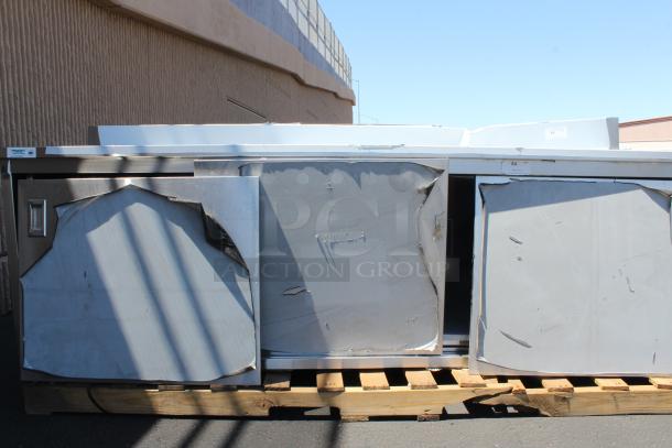 BRAND NEW SCRATCH-N-DENT! Regency 600EBTB3096D 30" x 96" 16 Gauge Type 304 Stainless Steel Enclosed Base Sliding Door Table with Adjustable Midshelf and 6" Backsplash. Unit is Dented. - Image 2 of 5