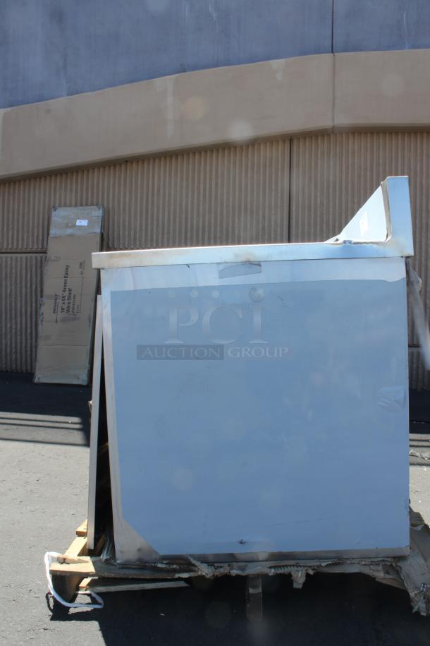 BRAND NEW SCRATCH-N-DENT! Regency 600EBTB3096D 30" x 96" 16 Gauge Type 304 Stainless Steel Enclosed Base Sliding Door Table with Adjustable Midshelf and 6" Backsplash. Unit is Dented. - Image 3 of 5